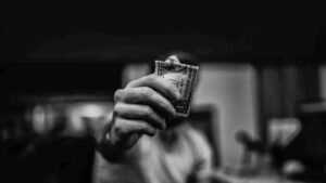 Man holding out a single crumpled dollar bill, the low-budget lead a contractor should disqualify